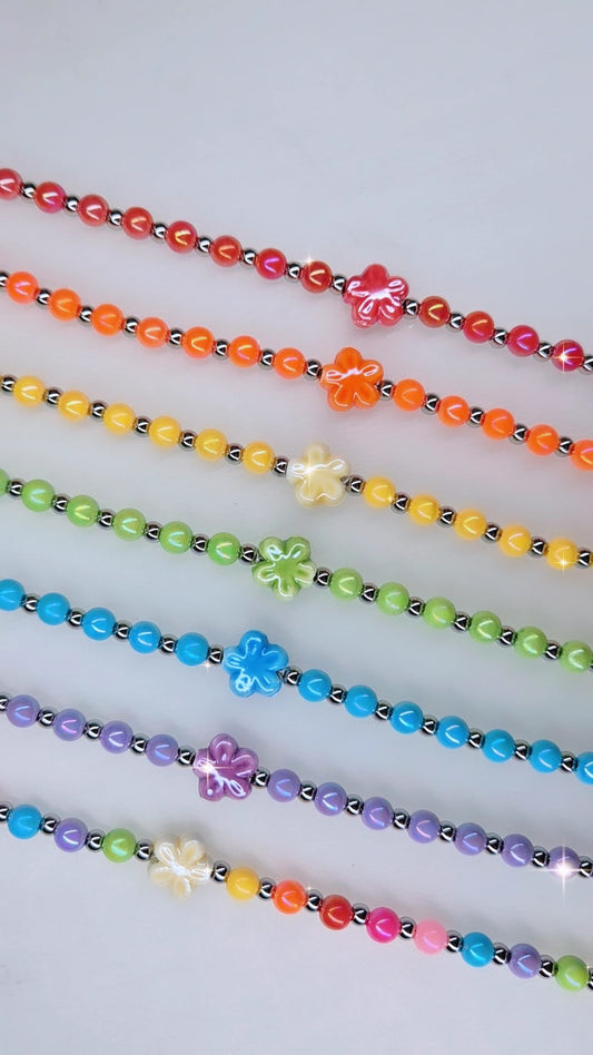 Bracciale Aloha 🌺 fiore centrale in ceramica, sfere acciaio silver alternate da sfere in resina colorata. Mis. regolabile