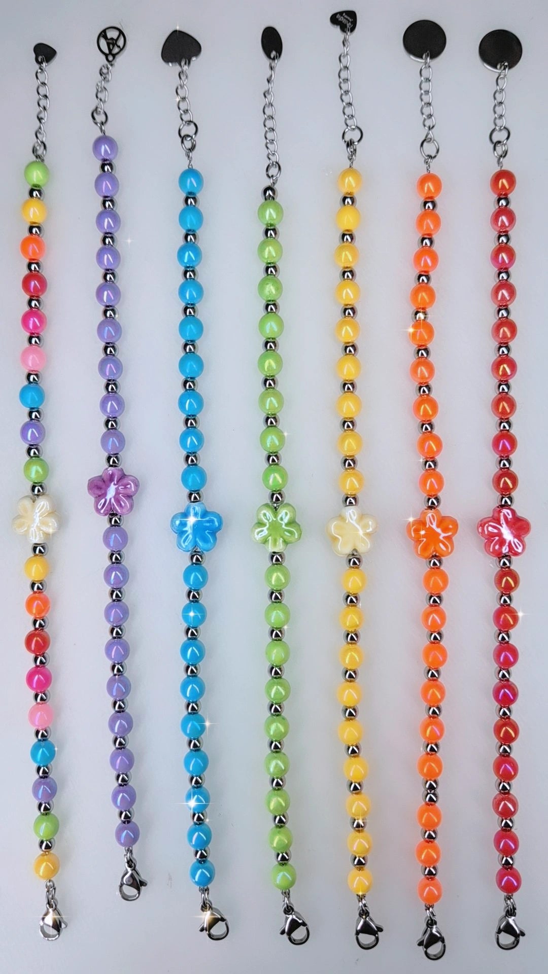 Bracciale Aloha 🌺 fiore centrale in ceramica, sfere acciaio silver alternate da sfere in resina colorata. Mis. regolabile